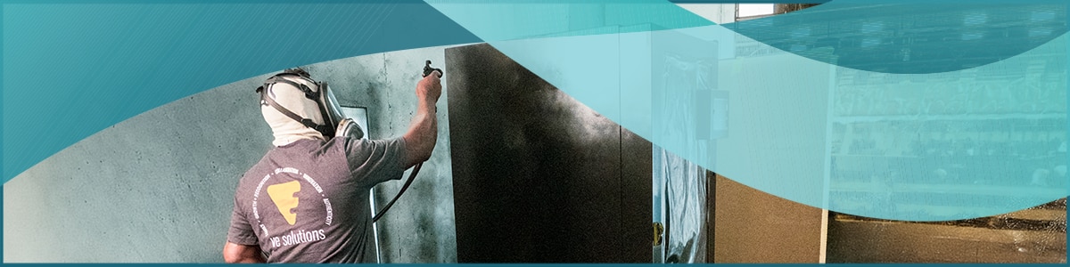 a VE Solutions employee spray paints a vending machine and a decorative teal wave element is on top of the image